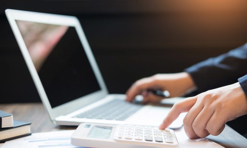 Administrator business man financial inspector and secretary making report, calculating balance. Internal Revenue Service checking document. Audit concept