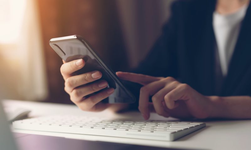 Woman using smartphone. The concept of using the phone is essential in everyday life.